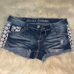 Almost Famous Women's Distressed Blue Jean Shorts with Lace